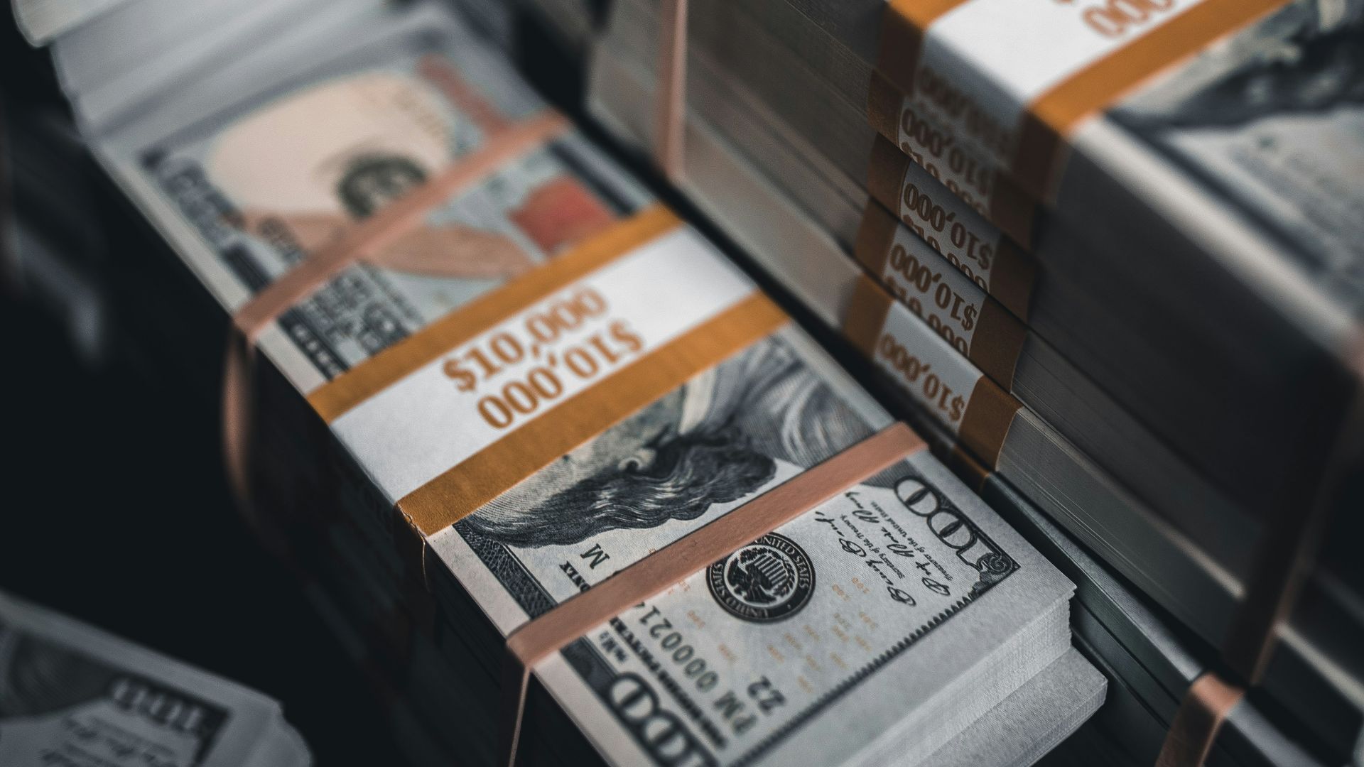 a pile of twenty dollar bills sitting on top of each other