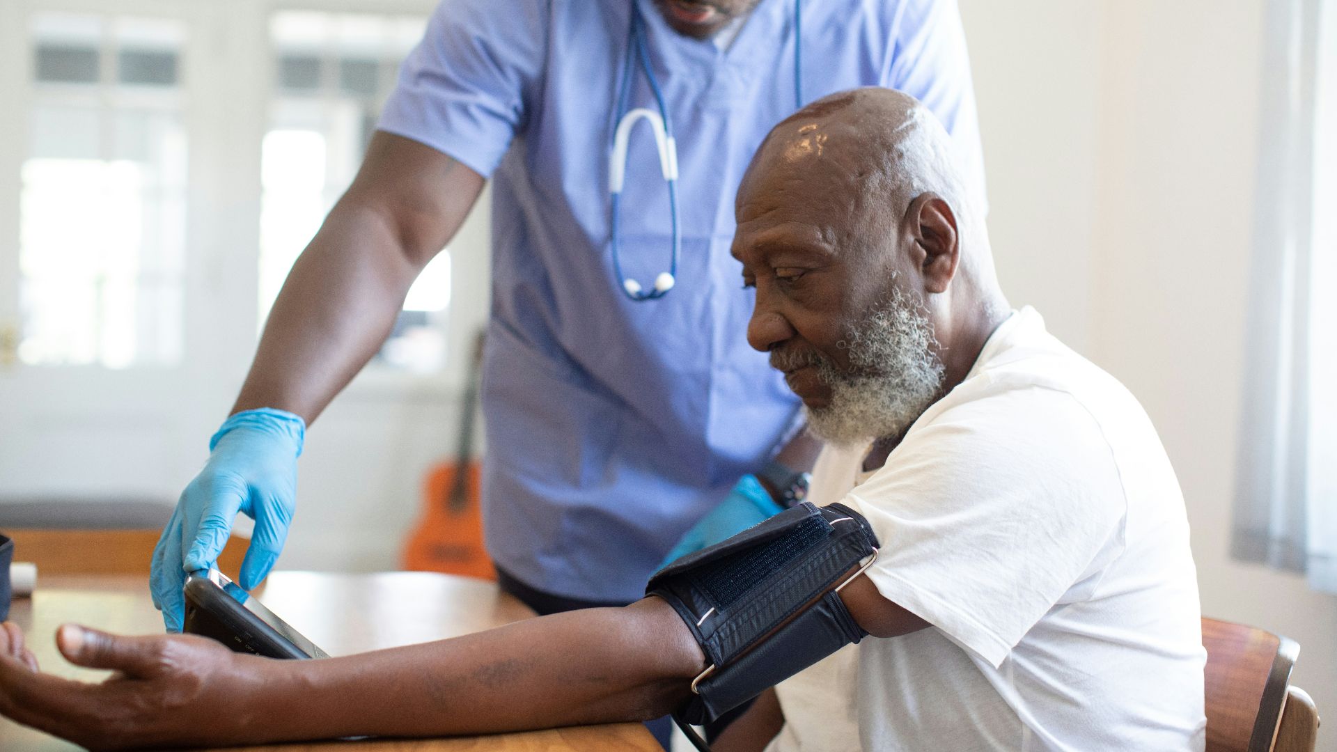 a doctor checking a patient's blood pressure