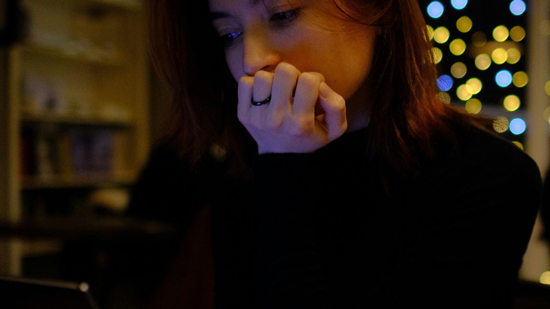 A woman sitting in front of a laptop computer