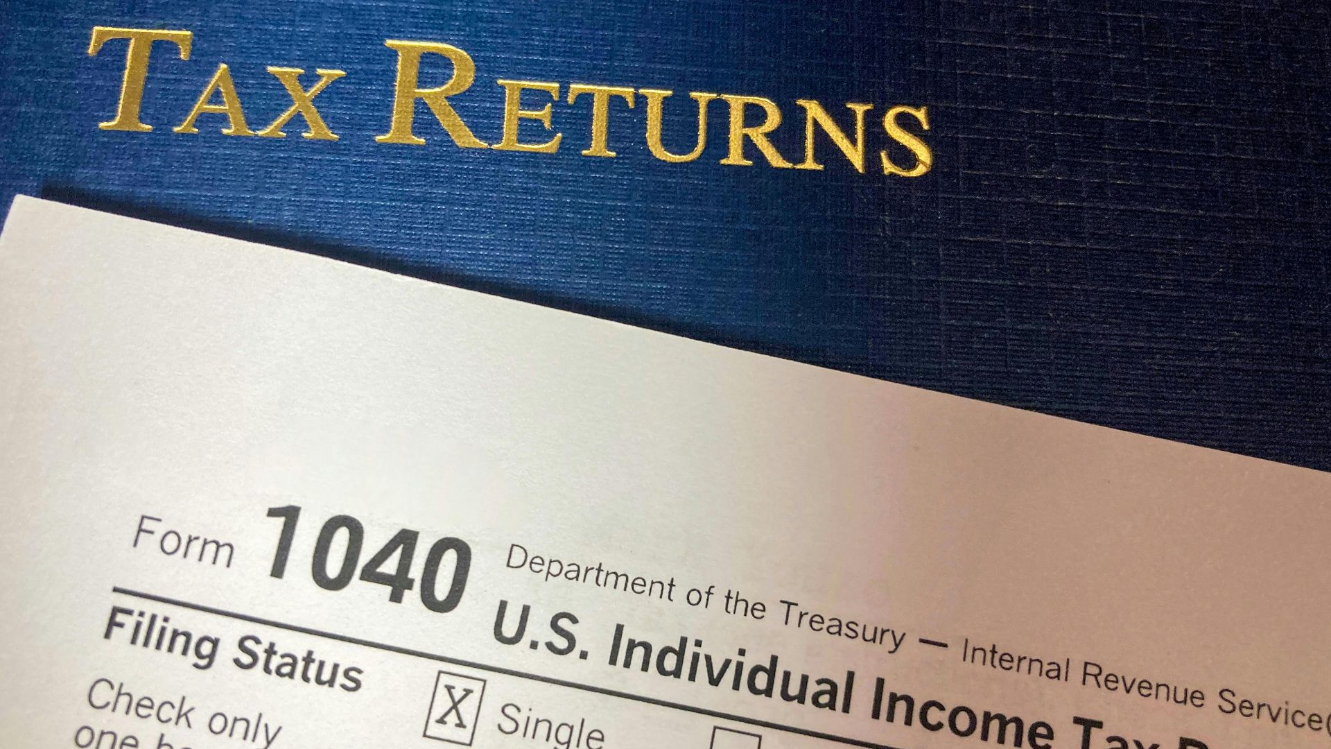 Close-up image of Form 1040 for U.S. tax returns, highlighting filing status options.