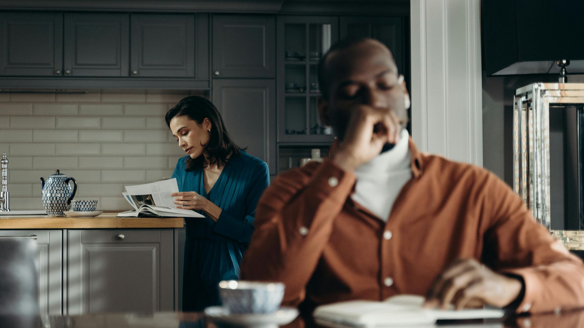 Elegant indoor scene of a couple enjoying a morning, reading and drinking coffee.