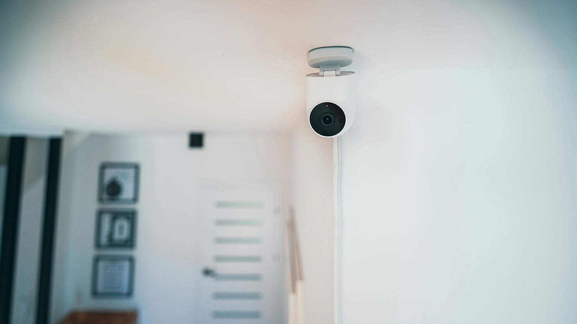 A sleek indoor security camera installed in a contemporary home for monitoring and safety.