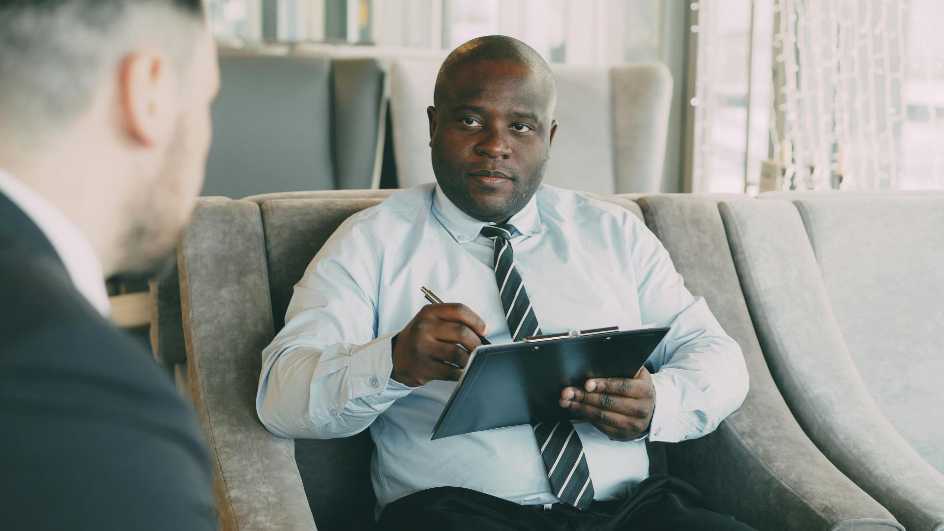 Professionals having a business meeting in a modern cafe with a relaxed atmosphere.