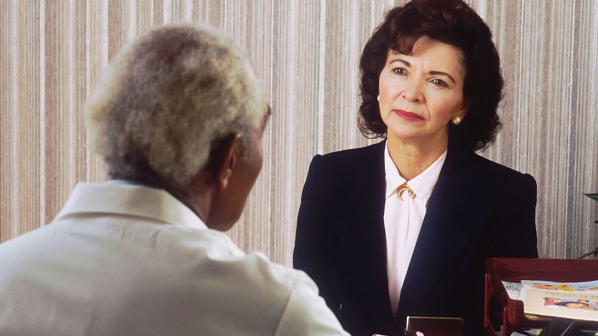 man in black suit jacket standing beside woman in white dress shirt