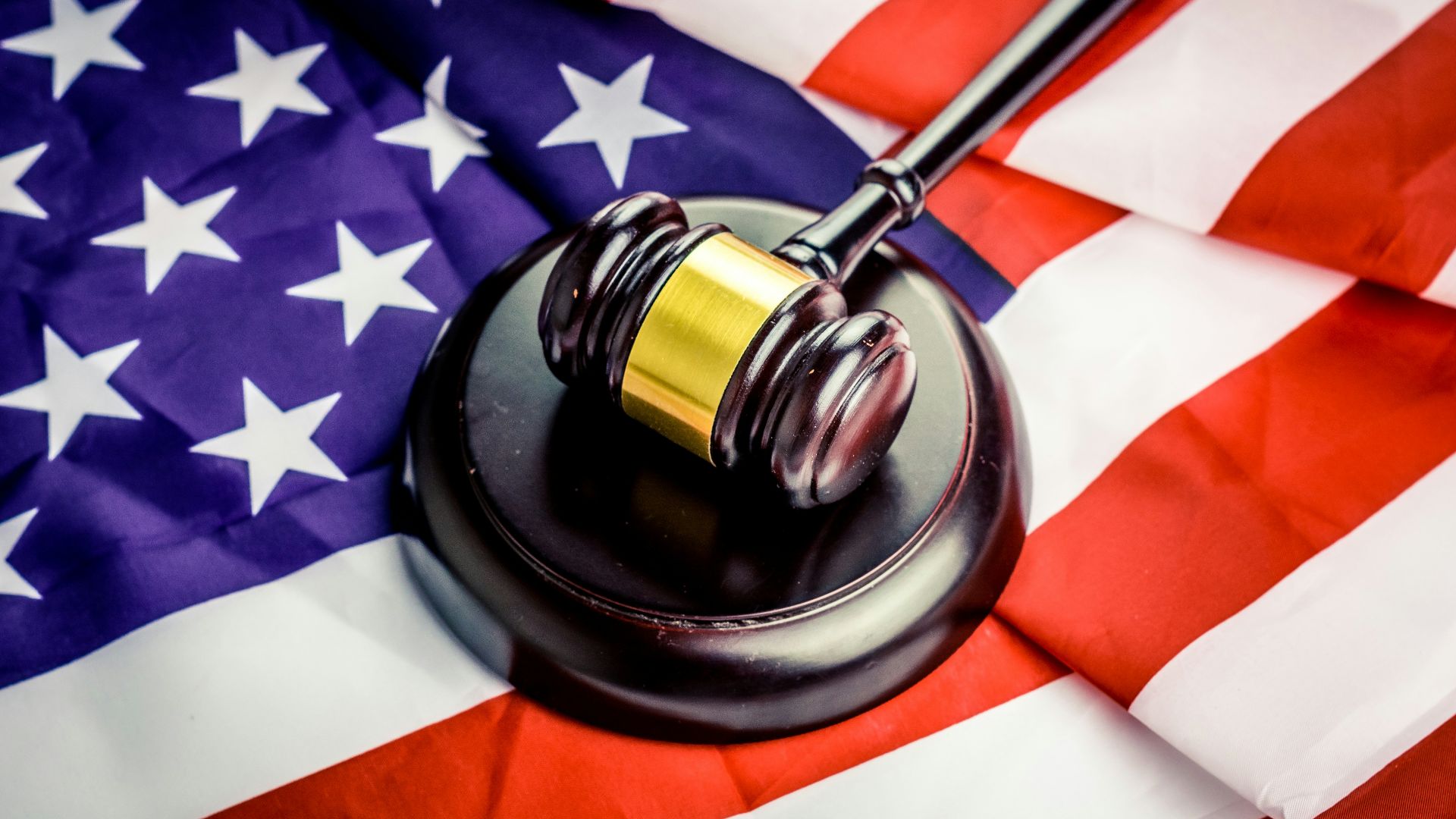 a judge's gavel on top of a flag
