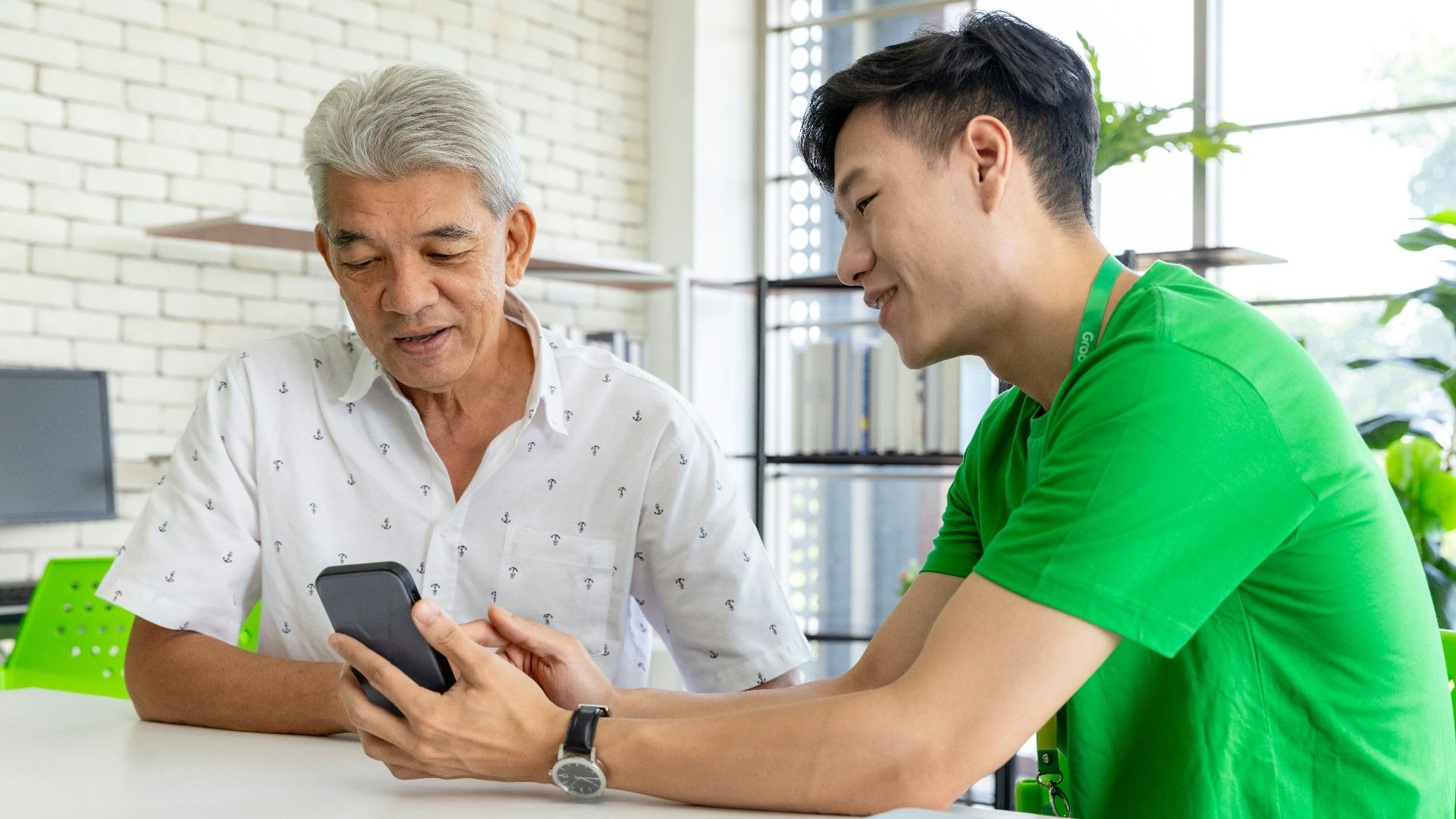 a man and a woman looking at a cell phone