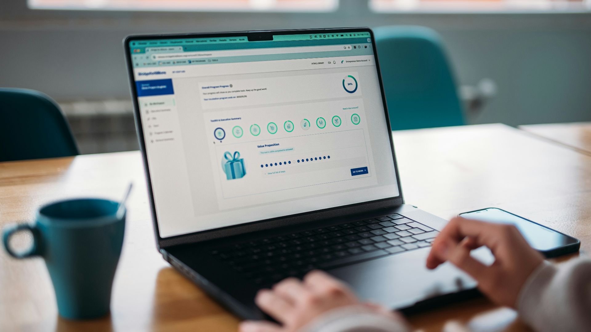 Person using a laptop to review a rewards program.