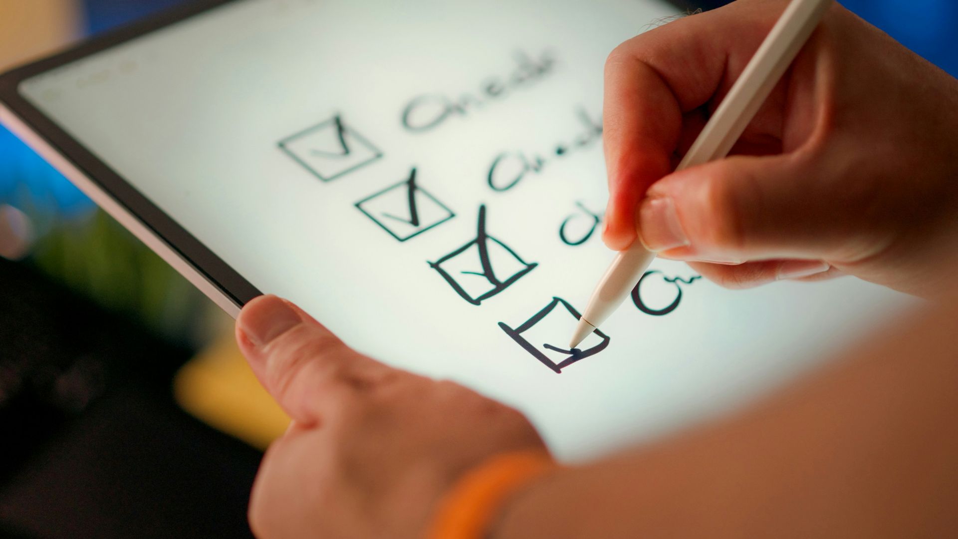 A hand marks off items on a checklist.