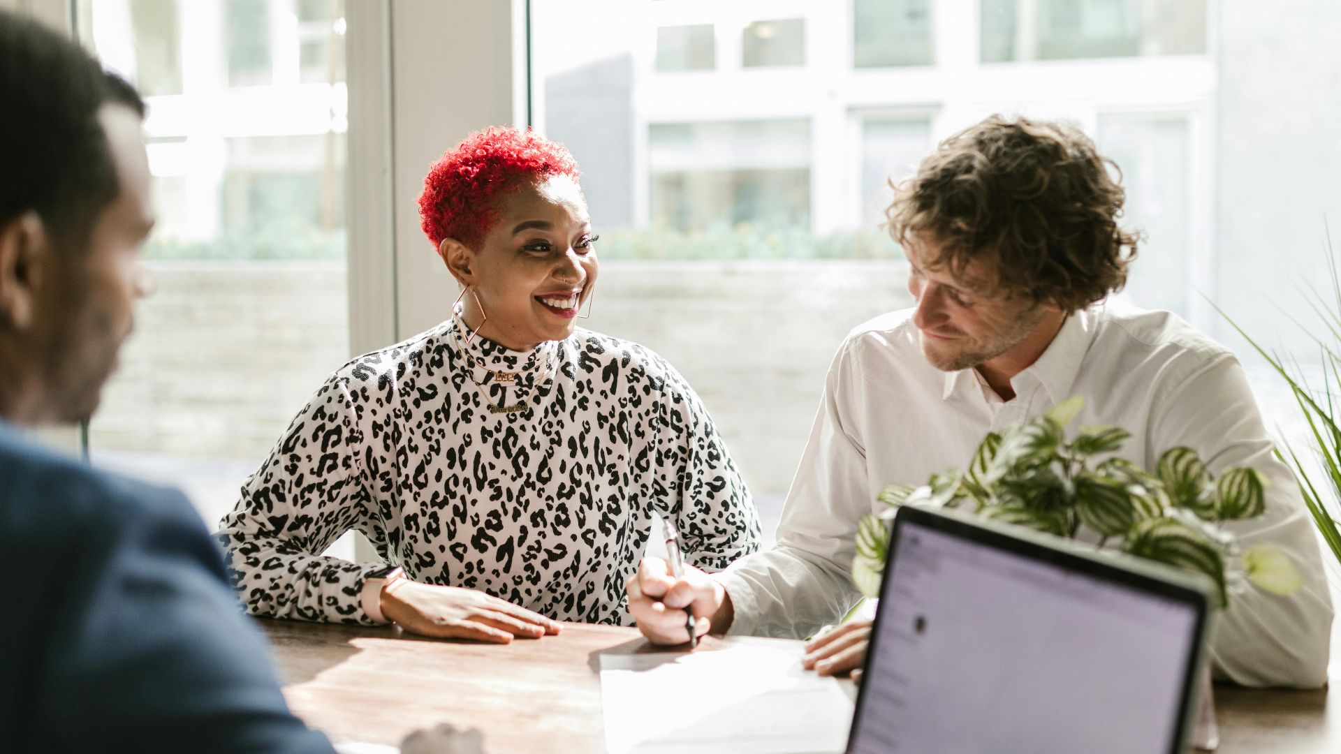 Casual business meeting with diverse professionals discussing a project.