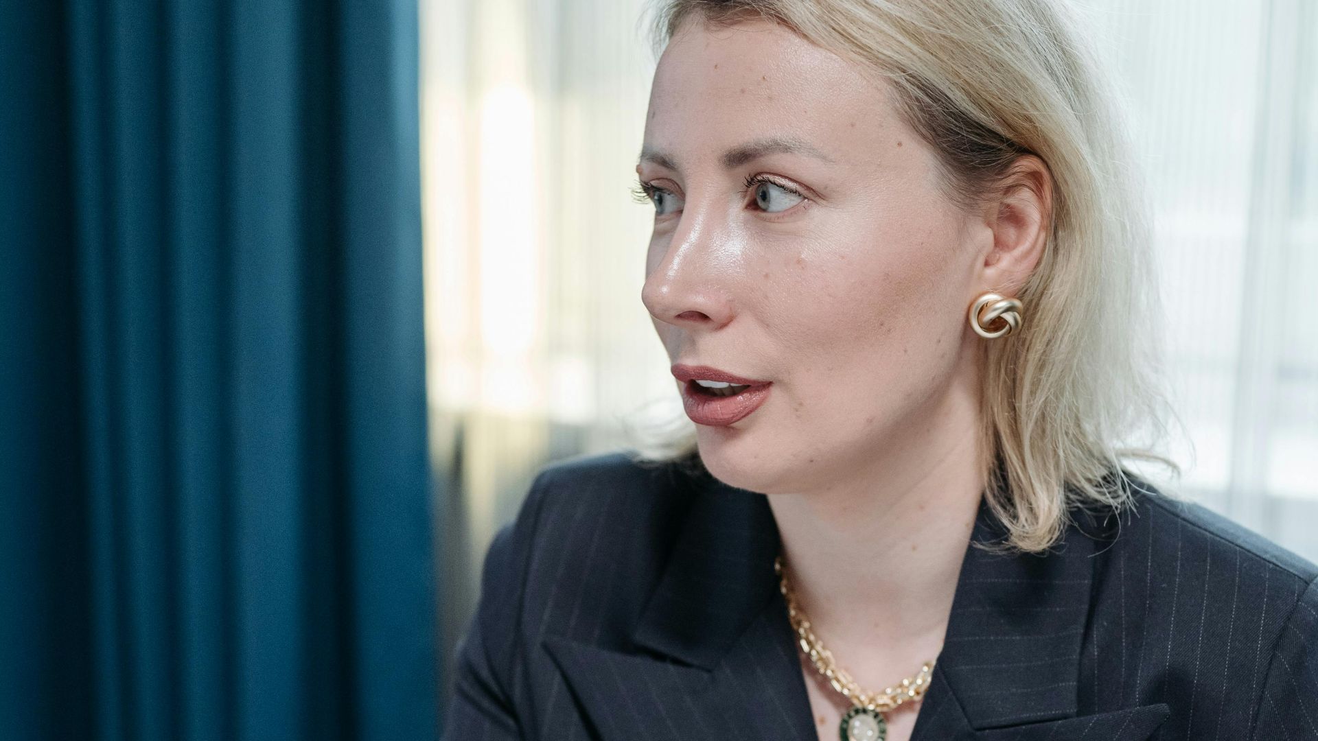Professional woman in discussion over a financial graph in an office setting.