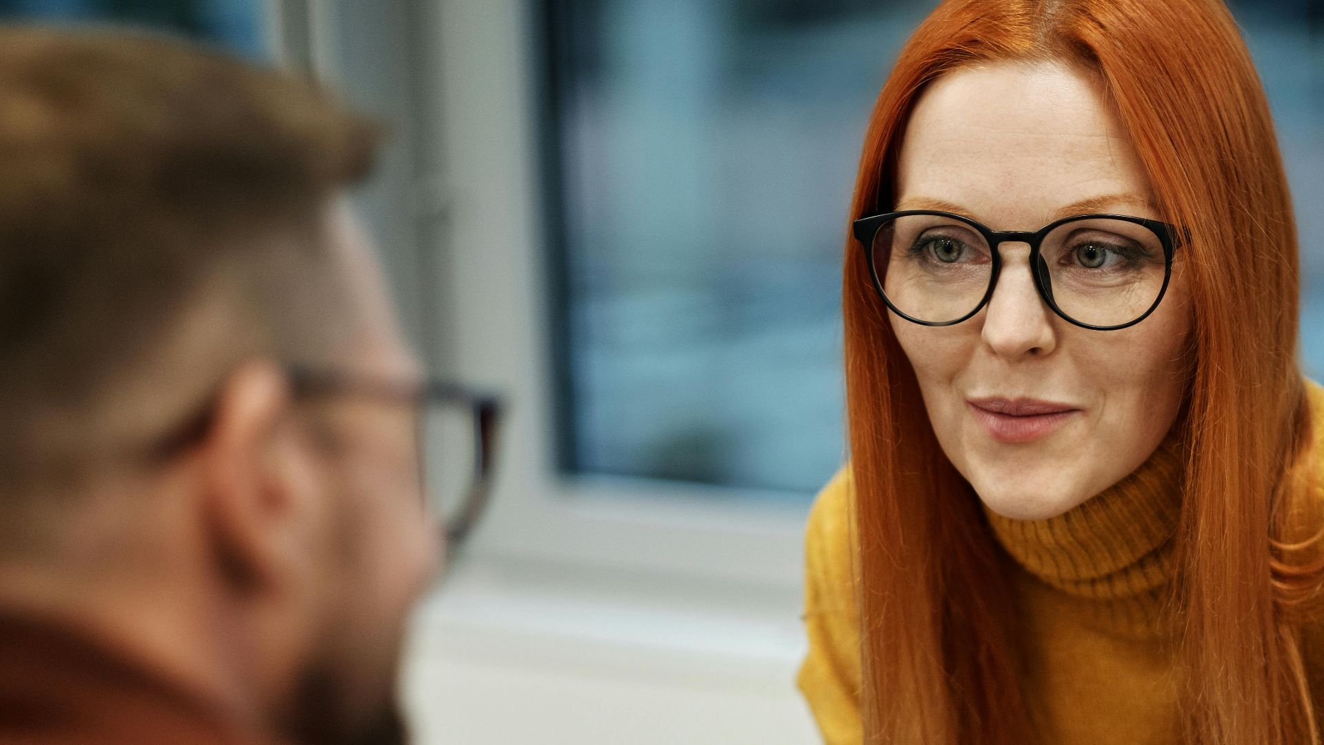Business colleagues engaging in a productive discussion in an office setting.