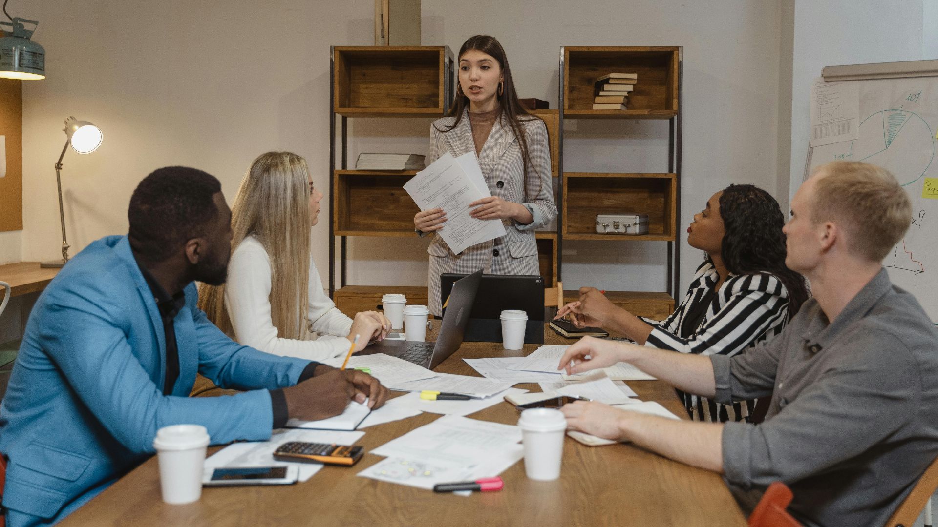 A diverse team of professionals in a creative office engaged in a collaborative business meeting.