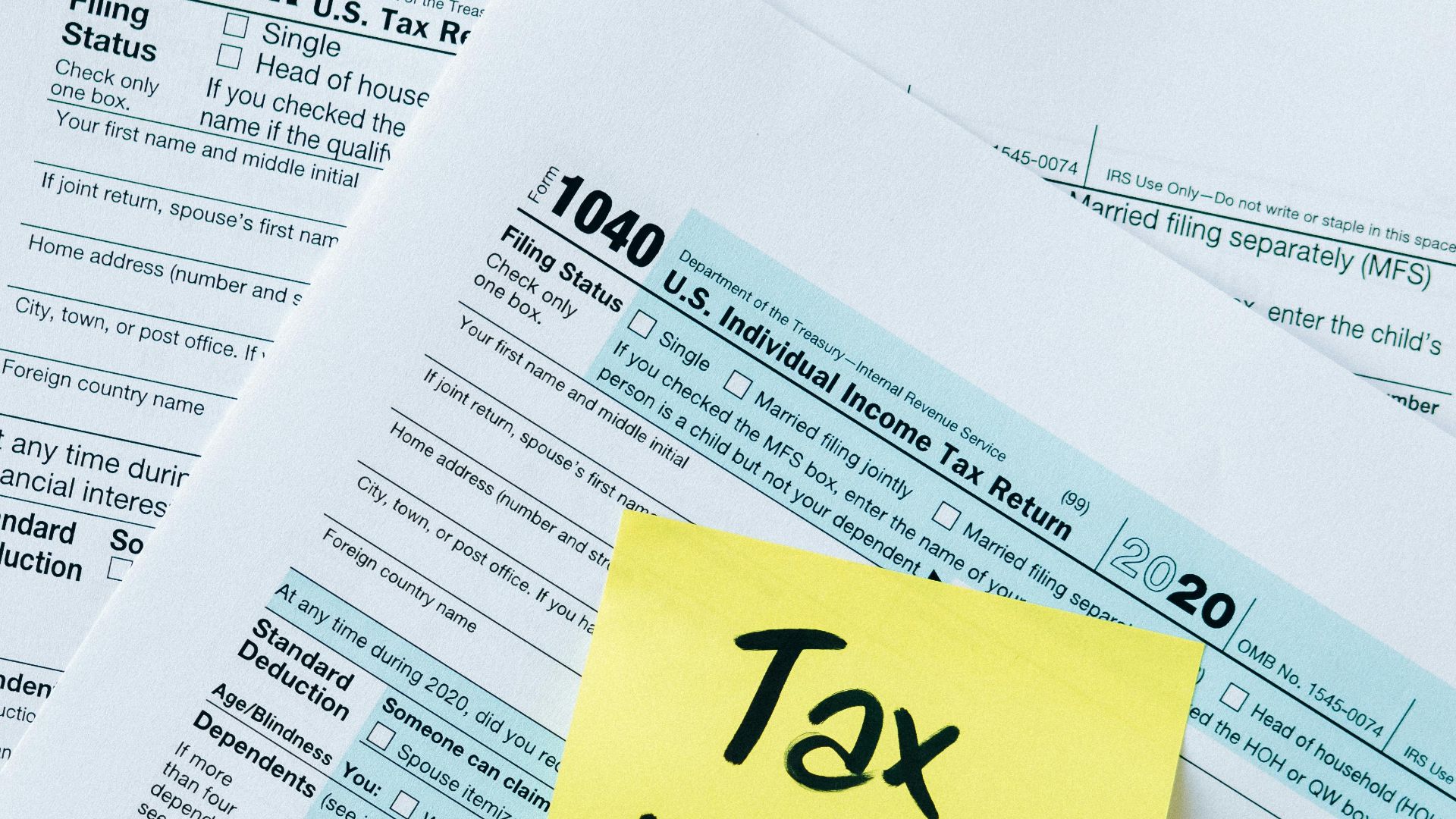 IRS 1040 tax forms with handwritten 'Tax Time!' note for filing reminder.