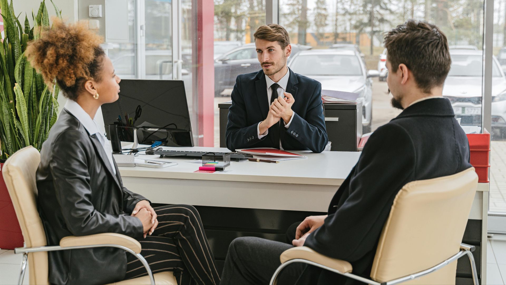 Professional meeting with clients at a modern office, discussing business solutions.