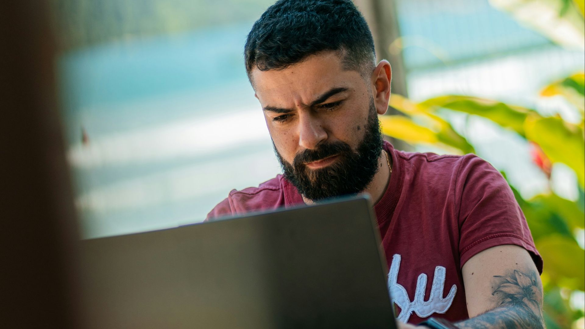 a man with a beard sitting at a table