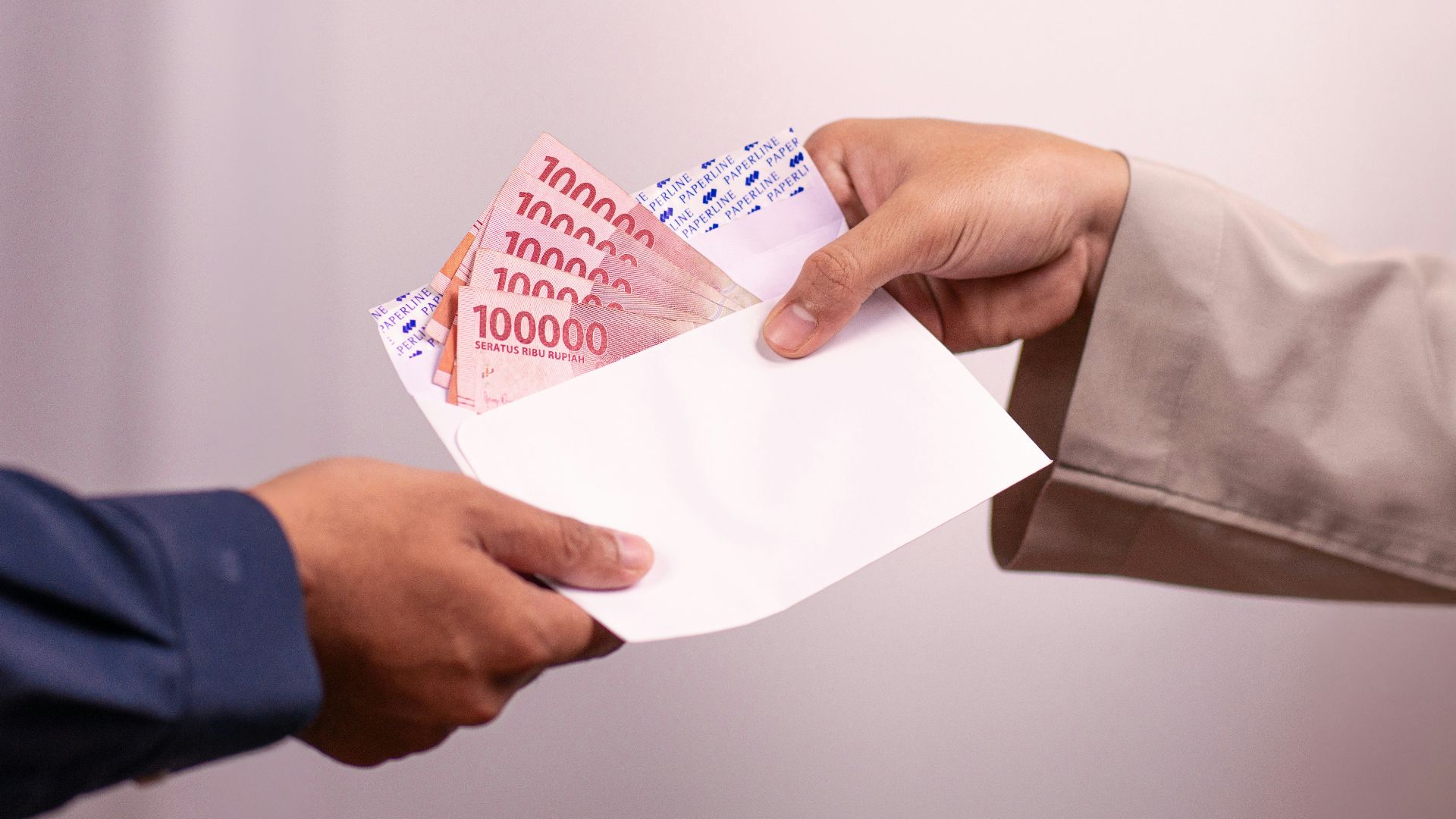 Money is being handed over between two people.