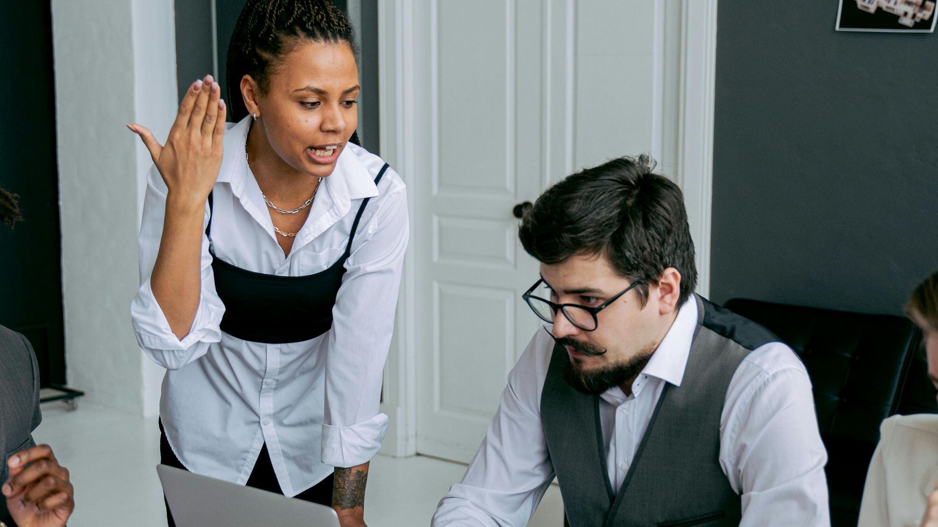 Business team in office, engaged in a serious discussion over deadlines and strategies.
