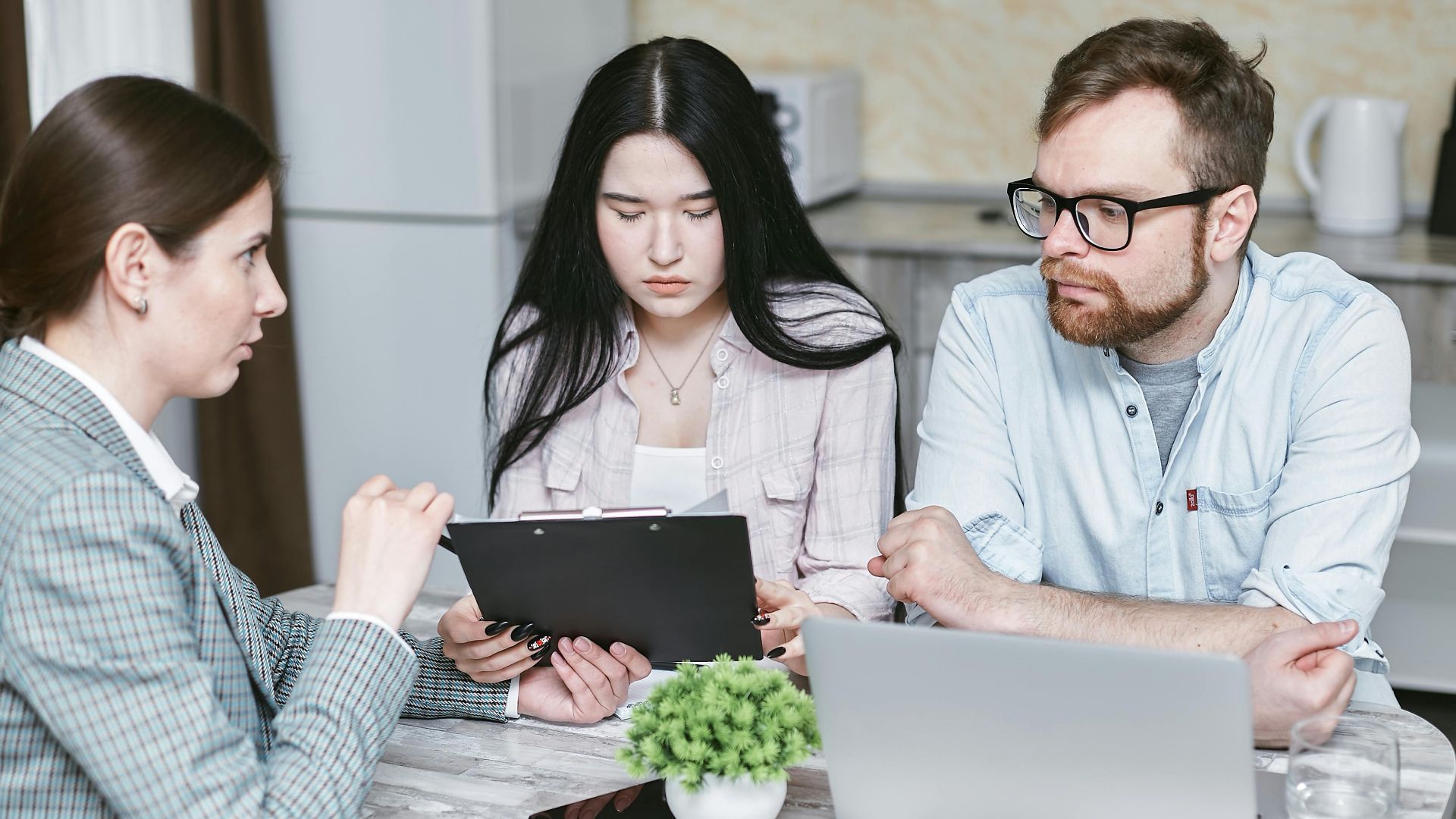 A group of professionals discussing business strategies at a table indoors.