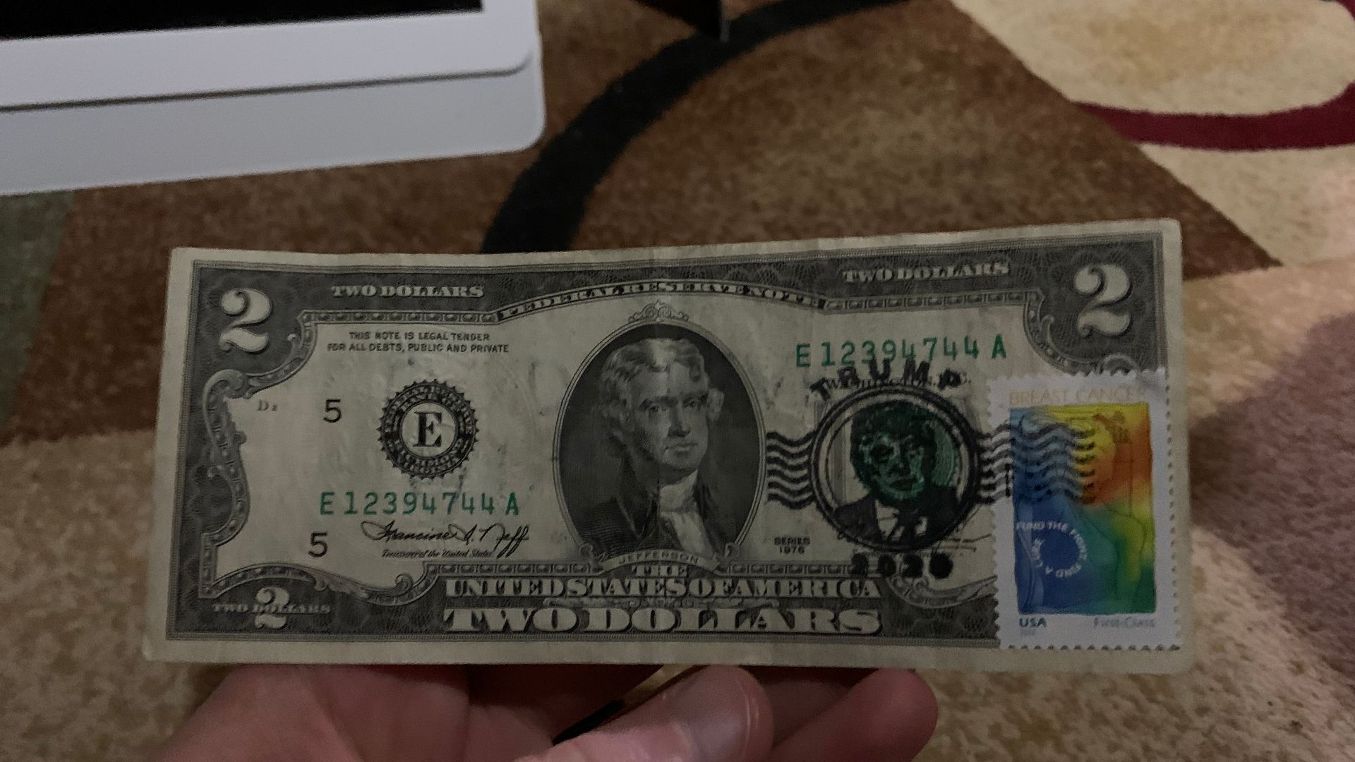 American two dollar bill which has been defaced with advertisements and political slogans