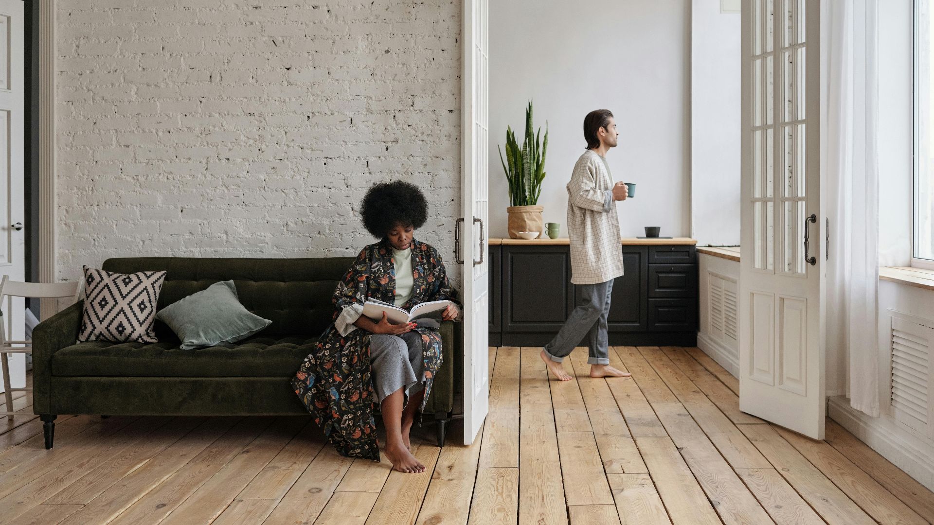 A serene scene of a couple enjoying leisure time in a stylish living room.
