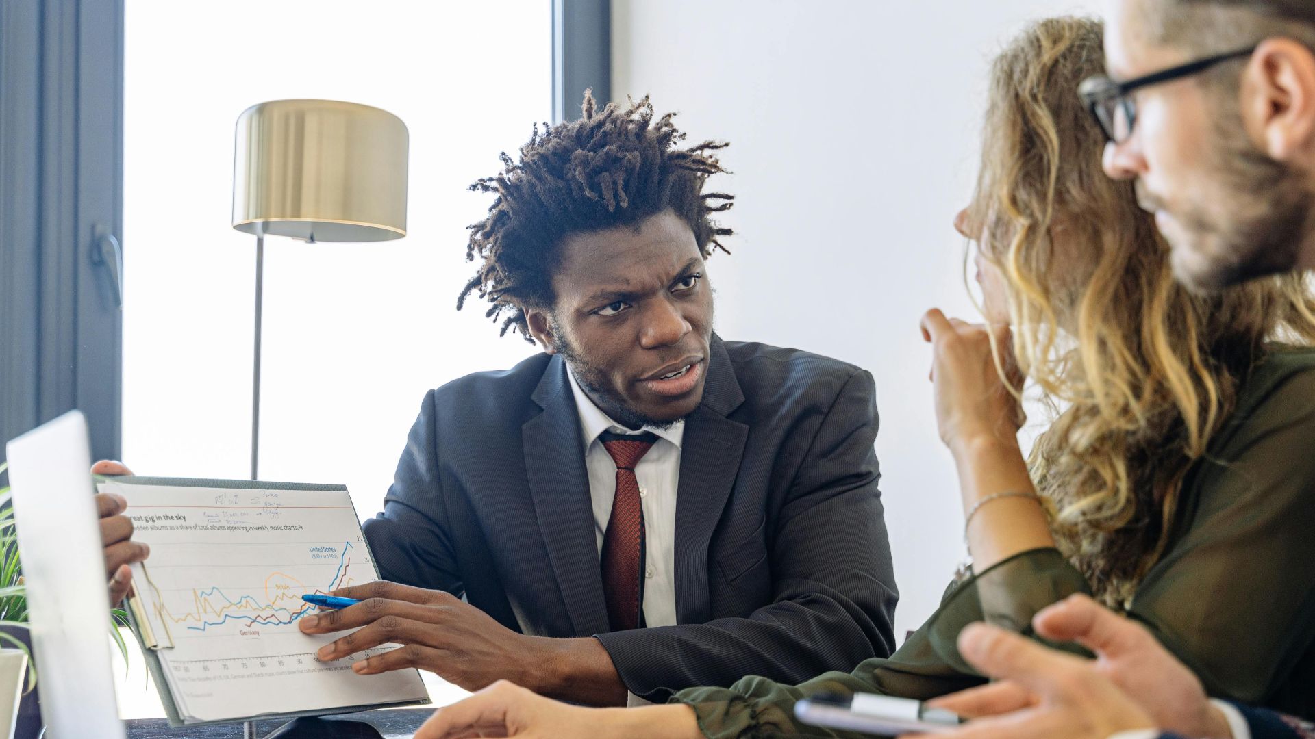 Business professionals discussing financial data during a collaborative meeting.