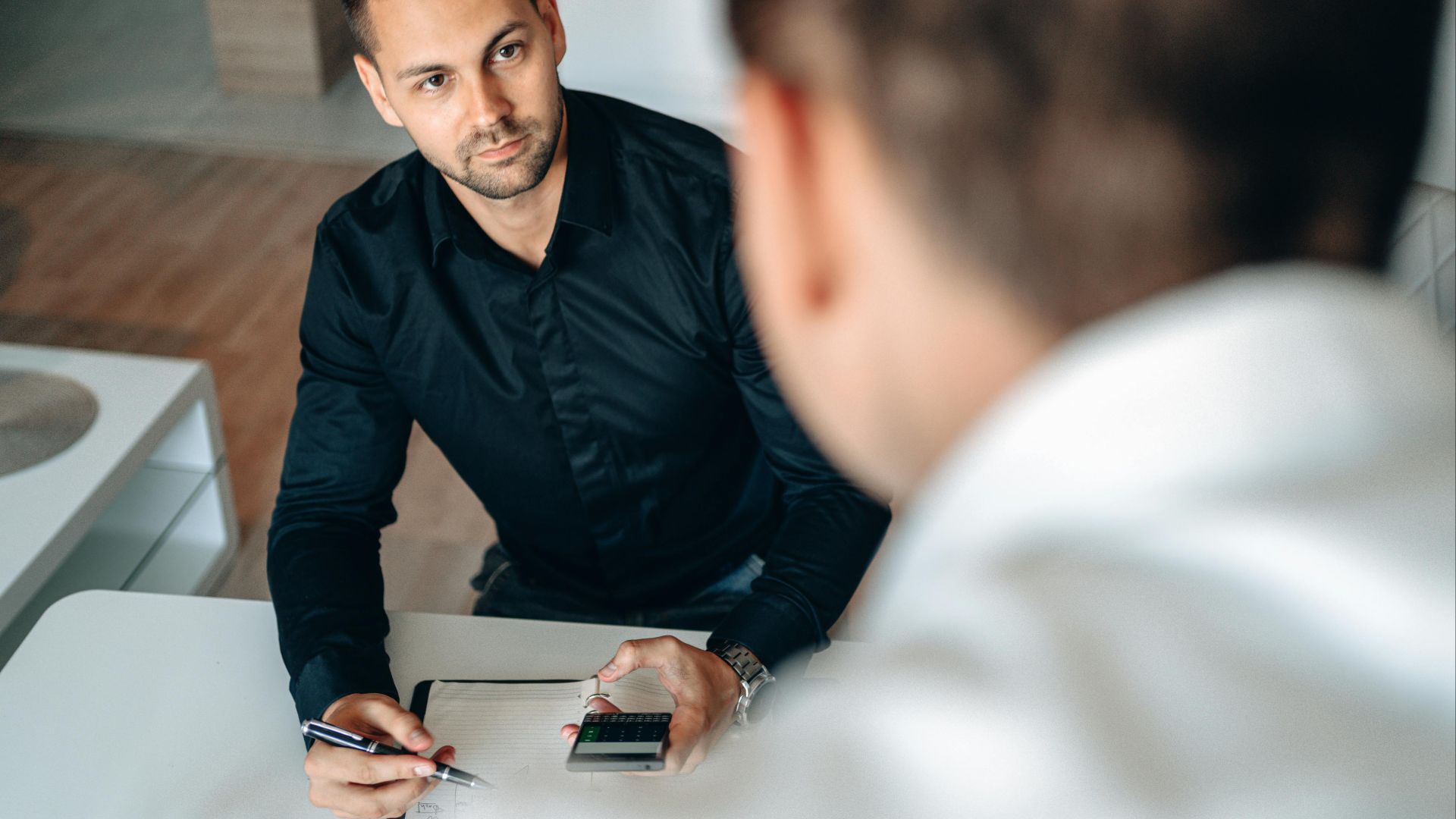 Men collaborating in an office setting, focused on planning and strategy.