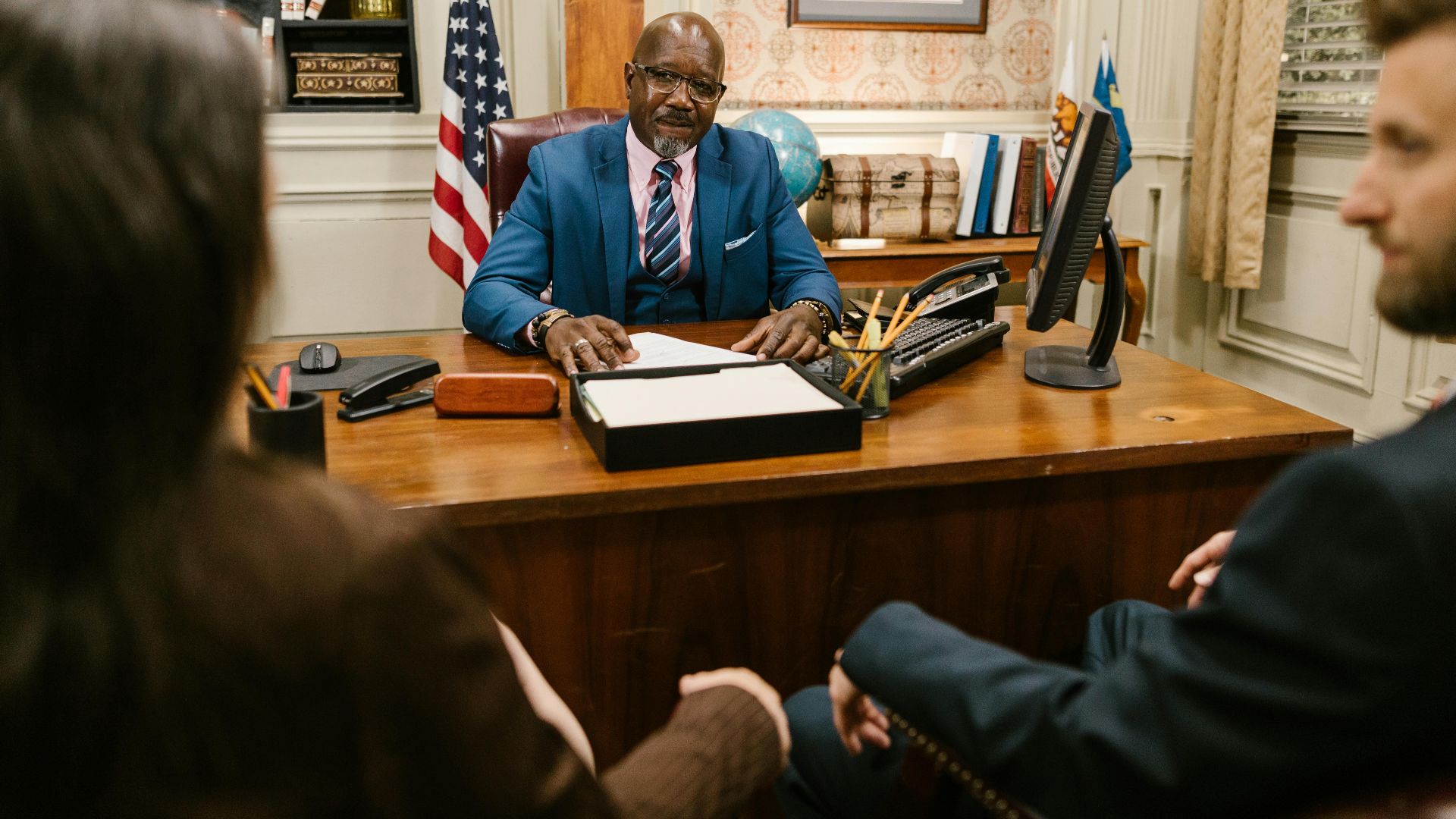 A professional lawyer meeting with clients in his office at a legal consultation.
