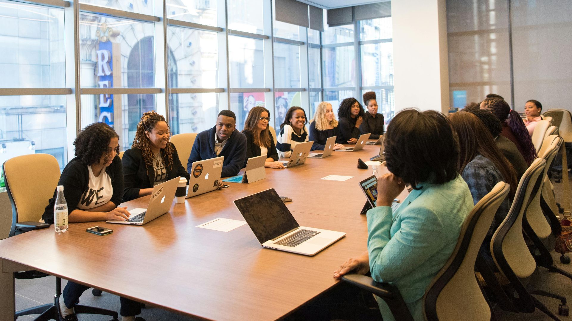 A diverse team of business professionals collaborating in a modern meeting room.