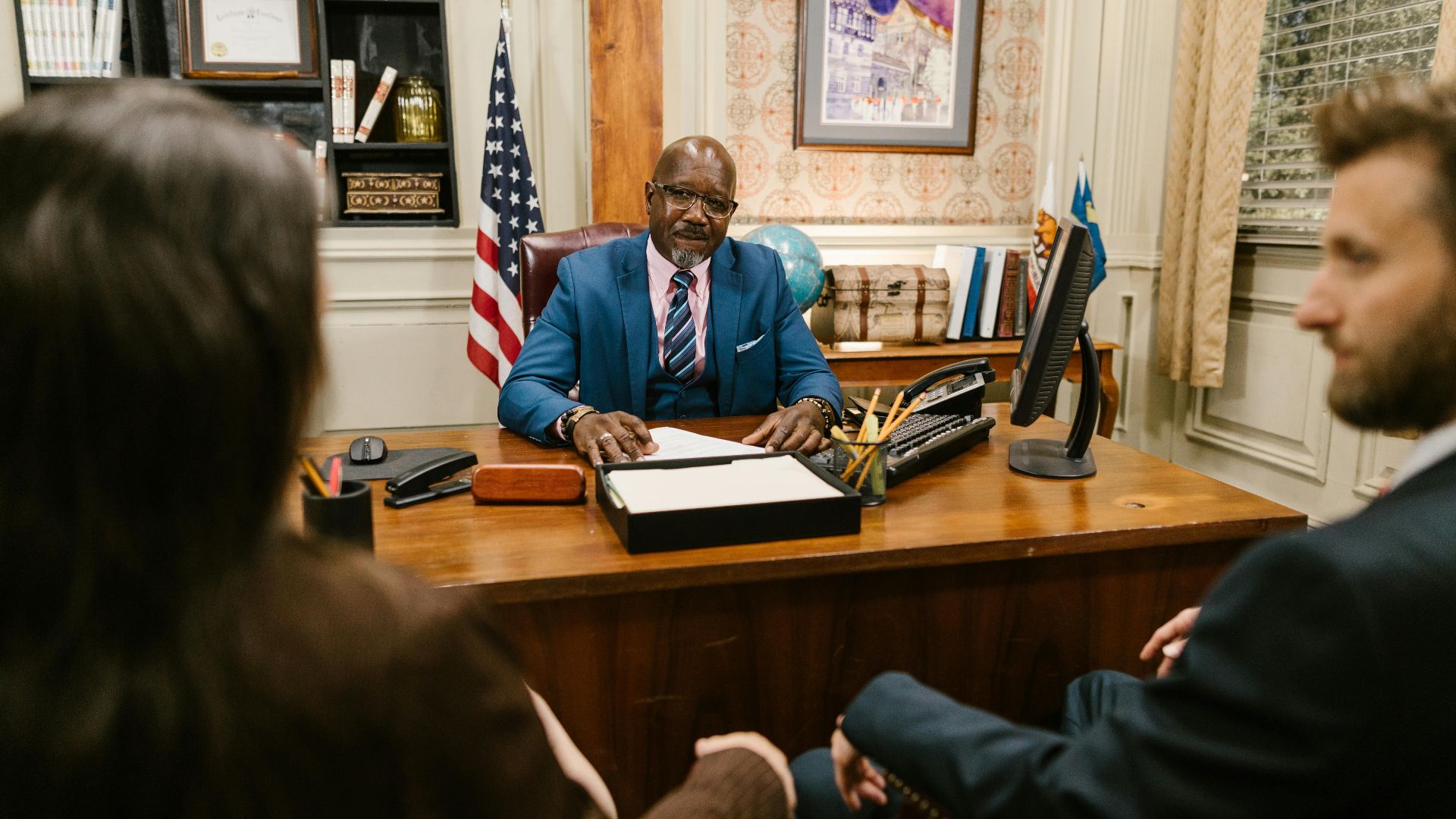 A professional lawyer meeting with clients in his office at a legal consultation.