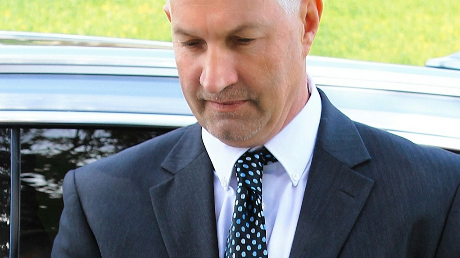 a man in a suit holding a tablet
