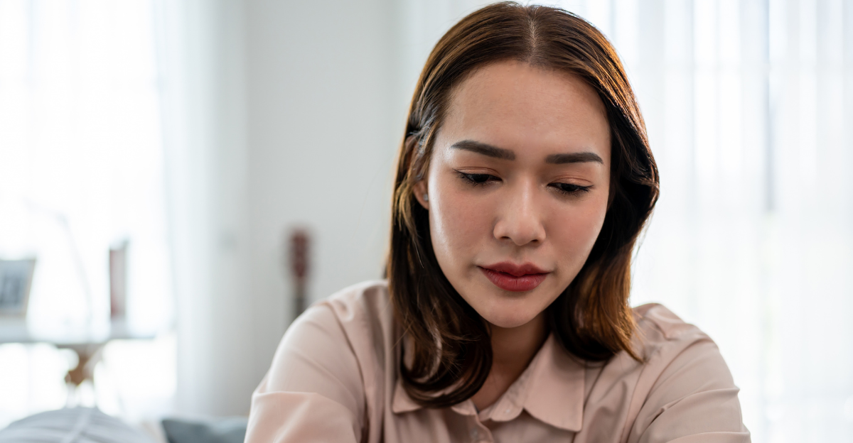 Asian upset depressed woman sitting alone