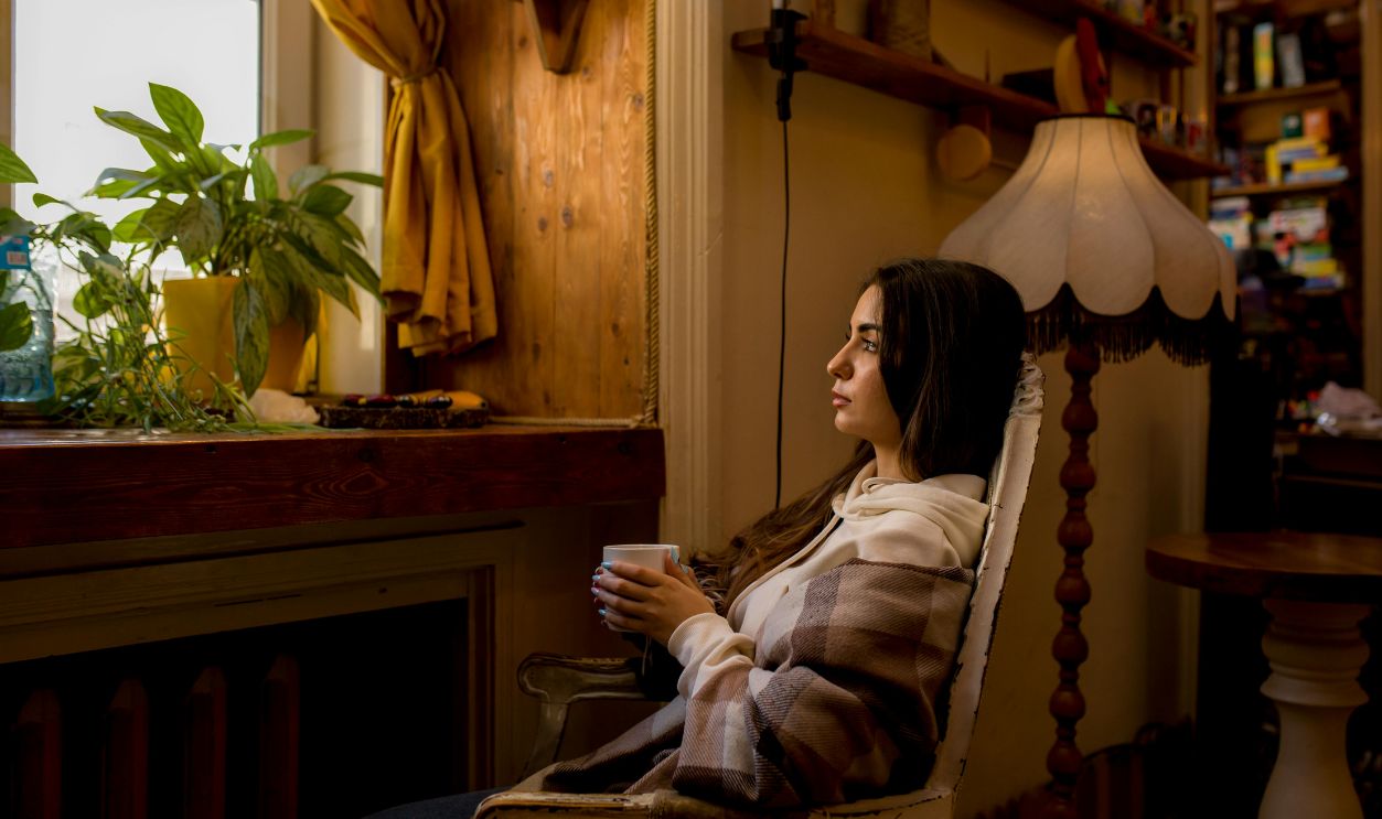 Woman Sitting and Posing on Armchair in Room