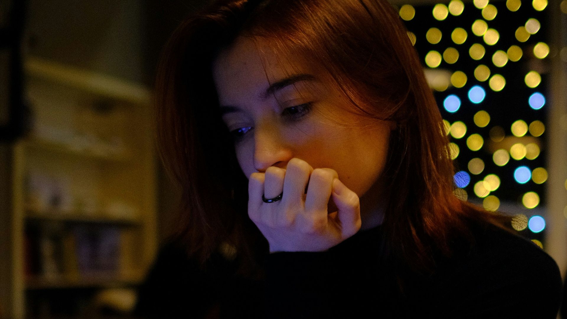 A woman sitting in front of a laptop computer