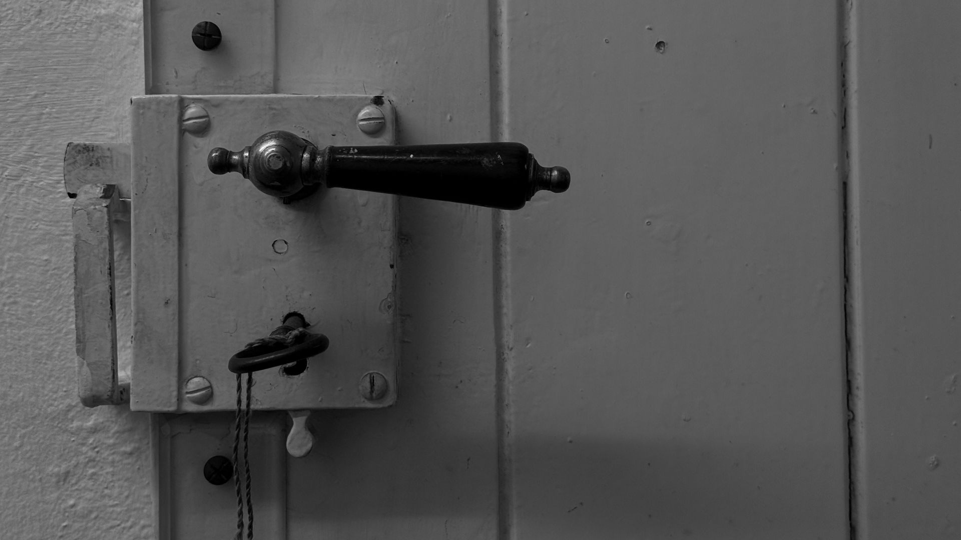 Close-up of an old door handle and lock with key.
