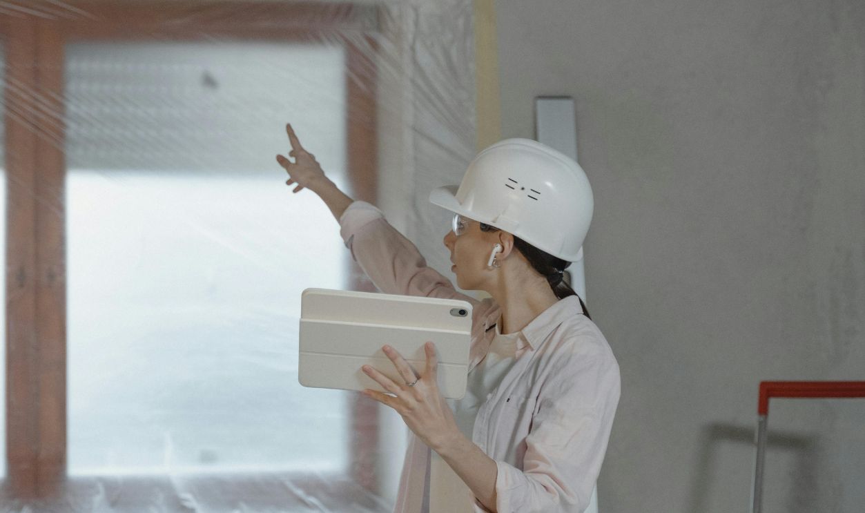 Woman Pointing to the Window while Holding the Ipad