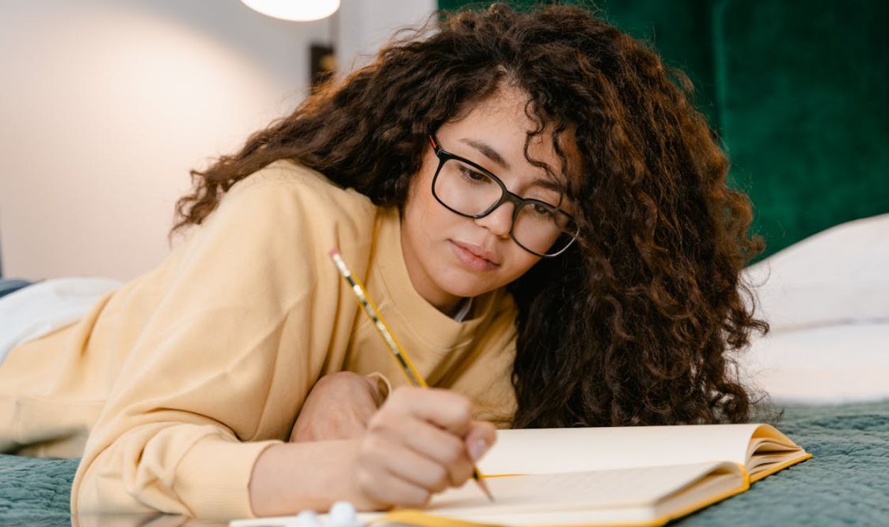 Girl Writing on a Notebook
