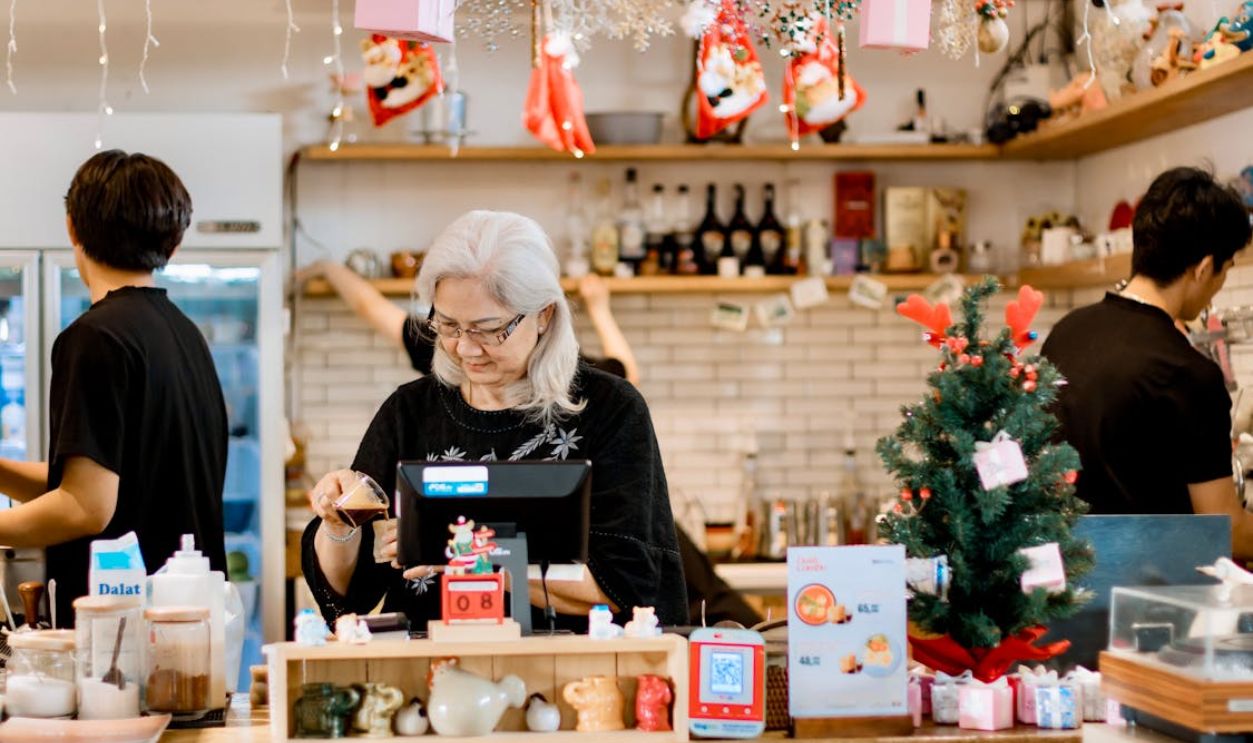 Festive Cafe Scene with Elderly Woman at Counter