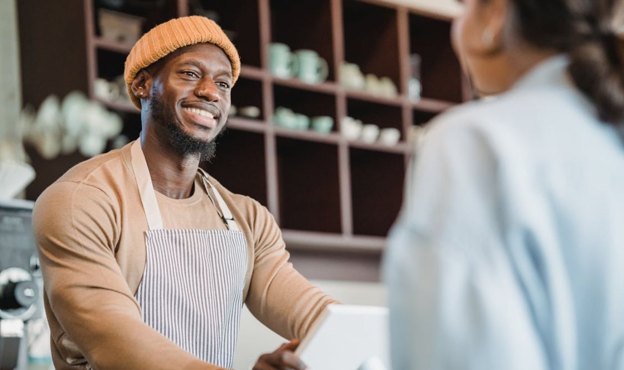 Woman Ordering Coffee in Cafe