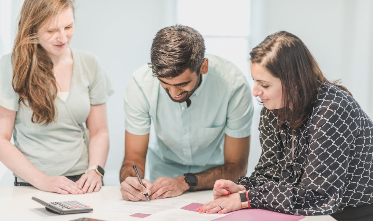 A Man Signing a Document