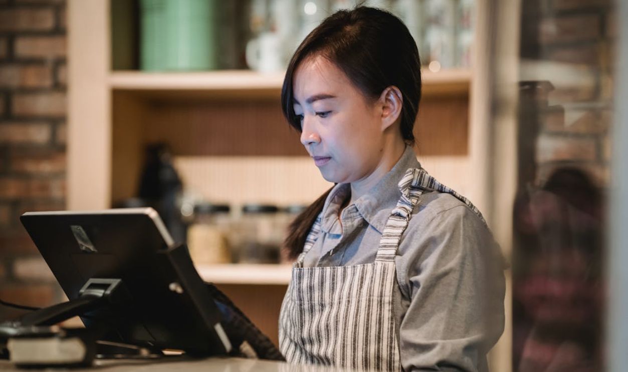 Woman Working at Cash Register