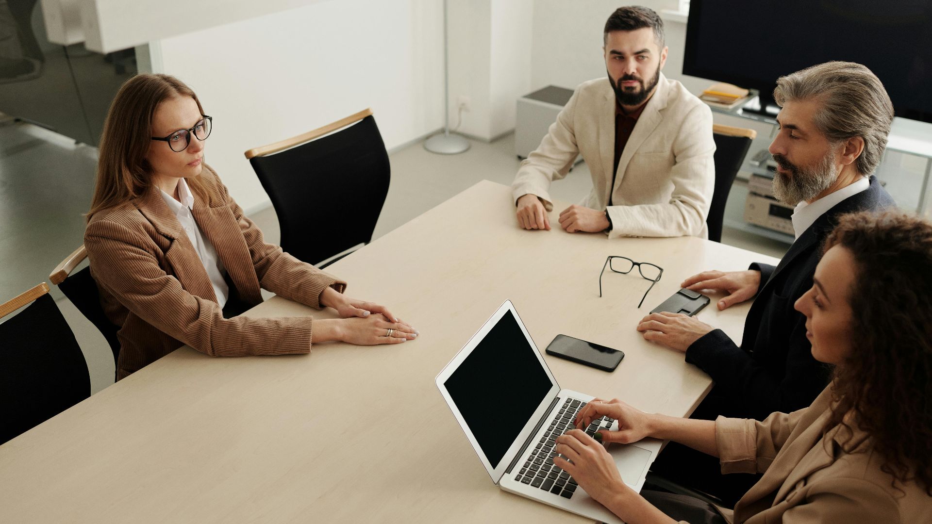 Group of professionals having a business meeting in a modern office setting.
