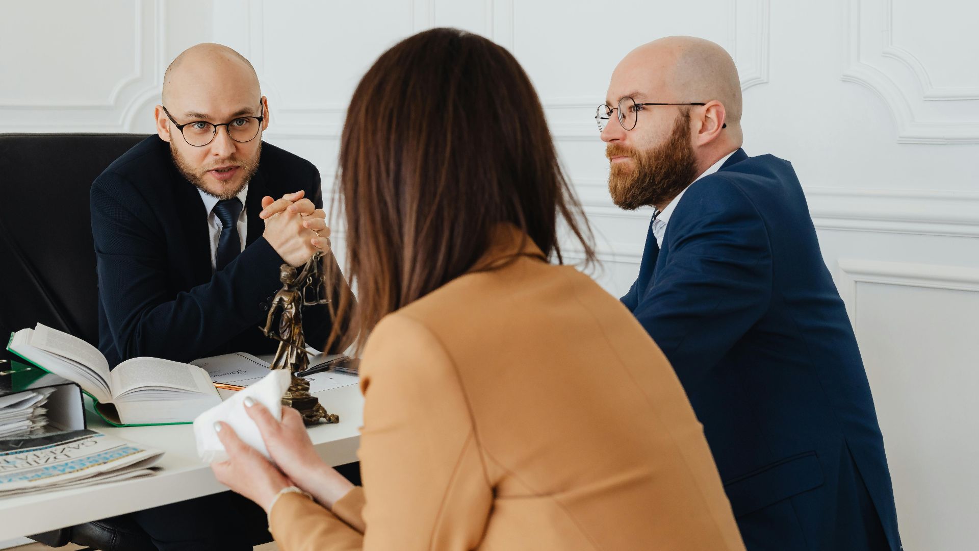 Professional discussion among lawyers in a modern office, focusing on legal matters.