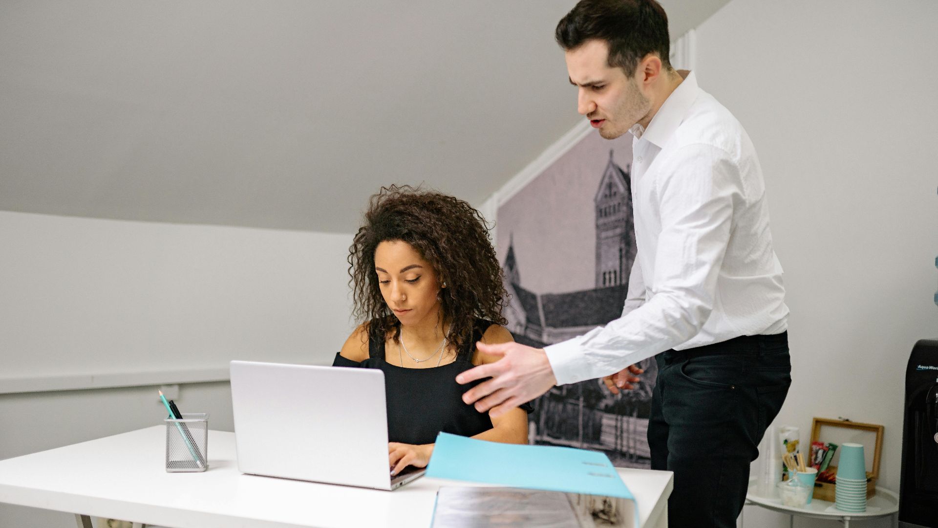 Manager and employee in discussion at the office, highlighting workplace dynamics.