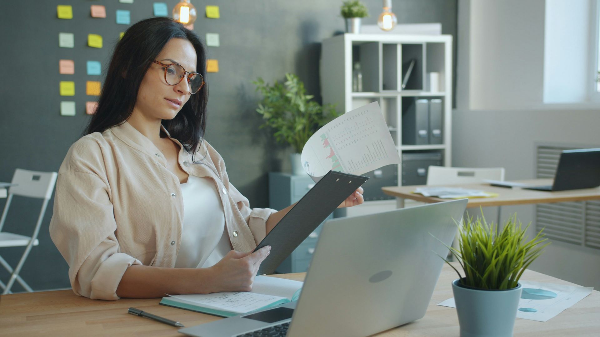 Woman working with documents at office desk