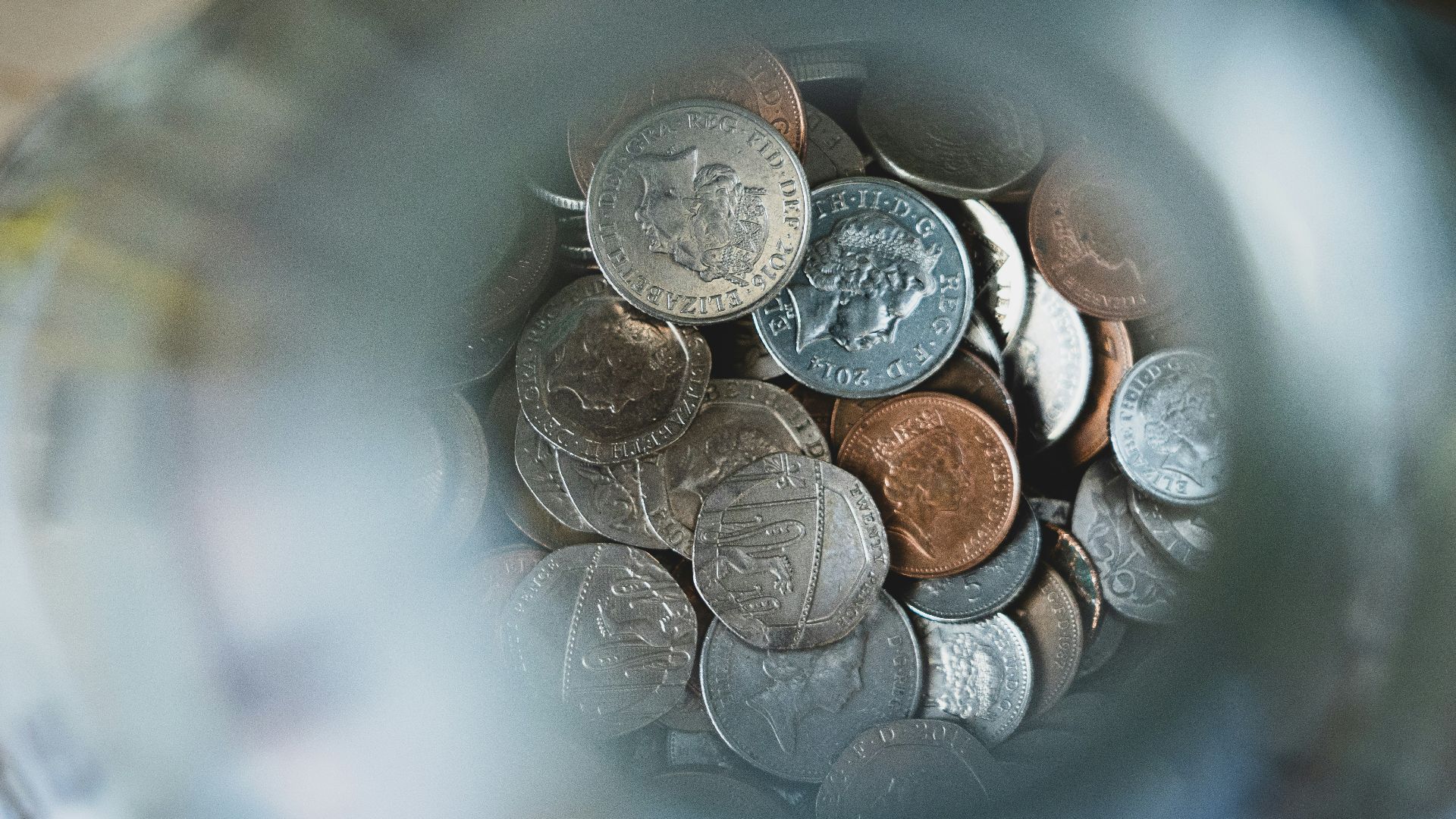 silver round coins on blue round container