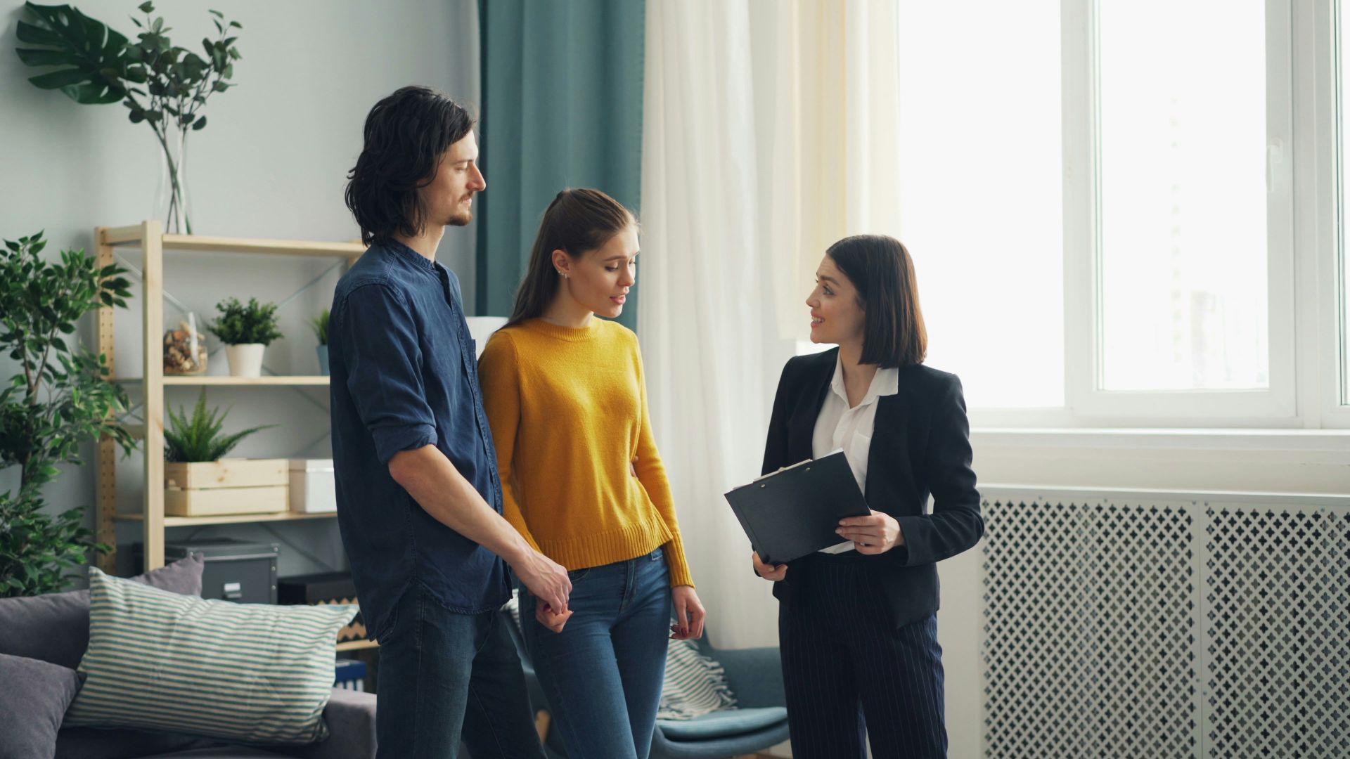 a group of people standing in a living room