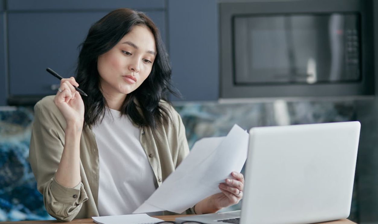 A Woman Looking at White Papers