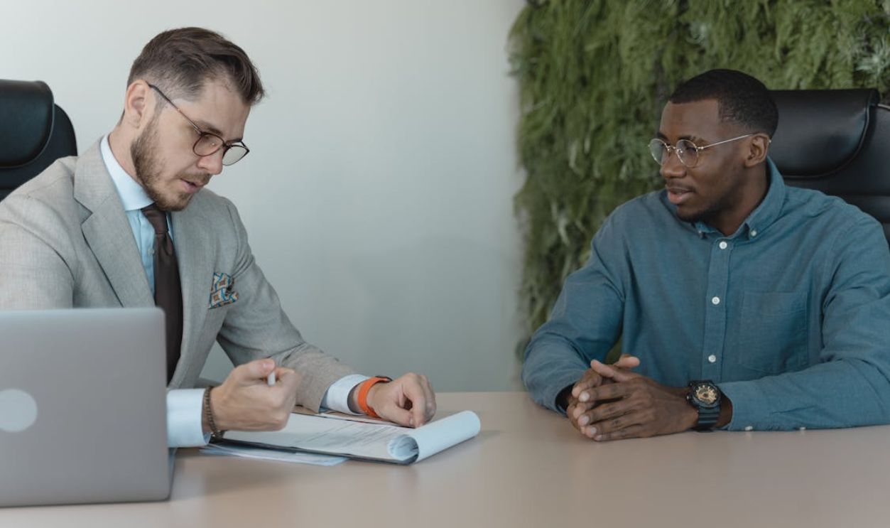 Man in Professional Clothing Reading a Resume