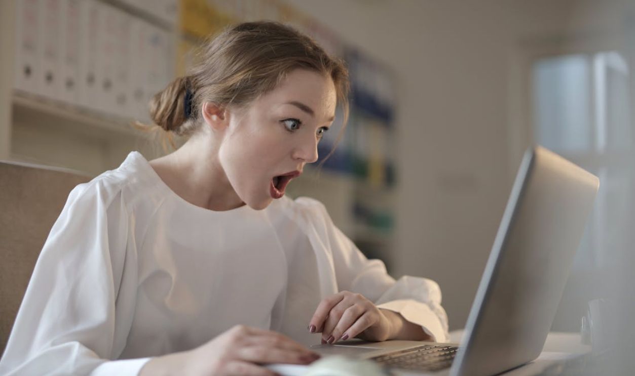 Woman in White Long Sleeve Shirt Using Silver Laptop Computer