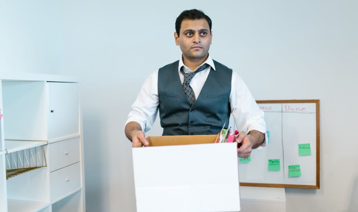 Man Carrying a White Box